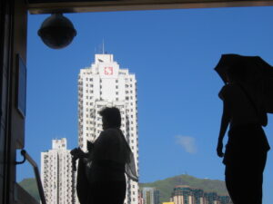 Silhouettes against buildings and sky